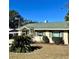 Cute yellow single story home with green roof and palm tree at 505 W 10Th Ave, Mount Dora, FL 32757