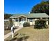 Charming single story home with green roof and walkway at 505 W 10Th Ave, Mount Dora, FL 32757