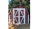 Rustic red storage shed with double doors at 505 W 10Th Ave, Mount Dora, FL 32757