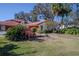 Spanish-style home with red tile roof, landscaping, and a two-car garage at 601 Waterwood Dr, Yalaha, FL 34797