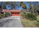 Attached garage with orange door and ample driveway space at 601 Waterwood Dr, Yalaha, FL 34797