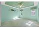 Light-filled bedroom with ceiling fan and large windows at 6319 Berkshire Pass, Leesburg, FL 34748