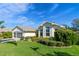 One-story house with a two-car garage and manicured landscaping at 6319 Berkshire Pass, Leesburg, FL 34748