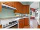 White appliances and oak cabinets in this well-lit kitchen at 6319 Berkshire Pass, Leesburg, FL 34748