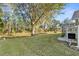 Spacious backyard with lush lawn and mature trees at 6525 Borg St, Leesburg, FL 34748