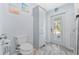 Bathroom with toilet, linen cabinet, and exterior access at 6525 Borg St, Leesburg, FL 34748