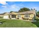 Single-story house with a screened porch and landscaped yard at 6525 Borg St, Leesburg, FL 34748