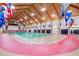 Indoor court with red running track and various flags at 6525 Borg St, Leesburg, FL 34748