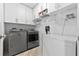 Bright laundry room with washer, dryer, and extra storage at 6525 Borg St, Leesburg, FL 34748