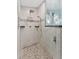 Large walk-in shower with marble tile and dual shower heads at 6525 Borg St, Leesburg, FL 34748