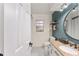 Updated bathroom with granite countertop and teal feature wall at 7237 Edmund Ct, Mount Dora, FL 32757