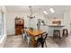 Bright dining area with wood table and metal chairs, adjacent to kitchen at 7237 Edmund Ct, Mount Dora, FL 32757