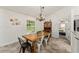 Cozy dining area with a wooden table and view into a bedroom at 7237 Edmund Ct, Mount Dora, FL 32757