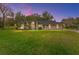 Beautiful home with well-manicured lawn at dusk at 7237 Edmund Ct, Mount Dora, FL 32757