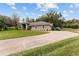 Single-story home with a large driveway and landscaped lawn at 7237 Edmund Ct, Mount Dora, FL 32757