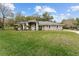 House exterior showcasing a well-maintained lawn and gray siding at 7237 Edmund Ct, Mount Dora, FL 32757