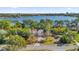 Aerial view of a house near a lake, showcasing a large backyard and city skyline in the distance at 7470 Lake Marsha Dr, Orlando, FL 32819