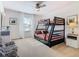 Bedroom with a full-over-full bunk bed and large window at 804 Orange Cosmos Blvd, Davenport, FL 33837