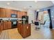 Open kitchen with granite island and stainless steel appliances at 804 Orange Cosmos Blvd, Davenport, FL 33837