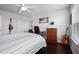 Bedroom with wood floors, striped bedding and large window at 810 Maplebrook Loop, Apopka, FL 32703