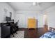 Bedroom with wood floors, desk, and built-in shelving at 810 Maplebrook Loop, Apopka, FL 32703