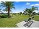 Relaxing community park with a bench, palm trees, and green grass at 810 Maplebrook Loop, Apopka, FL 32703