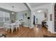 Bright dining room with white table and chairs, hardwood floors at 810 Maplebrook Loop, Apopka, FL 32703