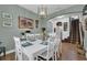 White dining table with chairs in a well-lit dining room at 810 Maplebrook Loop, Apopka, FL 32703