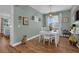 Spacious dining area with hardwood floors and white table set at 810 Maplebrook Loop, Apopka, FL 32703