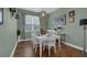 Charming dining room with white table and hardwood floors at 810 Maplebrook Loop, Apopka, FL 32703