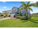 Two-story house with gray siding, landscaping, and a paved driveway at 810 Maplebrook Loop, Apopka, FL 32703