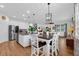 Bright kitchen with white cabinets, an island, and hardwood floors at 810 Maplebrook Loop, Apopka, FL 32703