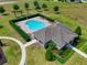 Community pool and clubhouse with lounge chairs and landscaping at 810 Maplebrook Loop, Apopka, FL 32703