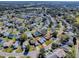 An aerial view of a house in a quiet, residential neighborhood setting at 830 Cortez Ave, The Villages, FL 32159