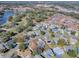 Aerial view of a house nestled in a residential neighborhood with lush greenery at 830 Cortez Ave, The Villages, FL 32159