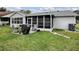 Landscaped backyard with patio and grill at 830 Cortez Ave, The Villages, FL 32159