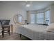 Bedroom with bay window, dresser, and comfy seating at 830 Cortez Ave, The Villages, FL 32159