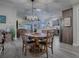 Open concept dining area with wood table and kitchen views at 830 Cortez Ave, The Villages, FL 32159