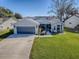 House exterior with well-maintained lawn and driveway at 830 Cortez Ave, The Villages, FL 32159