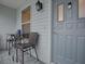 Cozy front porch with small table and chairs, perfect for relaxing at 830 Cortez Ave, The Villages, FL 32159