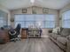 Bright home office features built-in shelving and large windows at 830 Cortez Ave, The Villages, FL 32159
