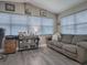 Spacious home office with large windows, comfortable sofa, and work area at 830 Cortez Ave, The Villages, FL 32159