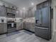 Modern kitchen boasts stainless steel appliances and wood cabinets at 830 Cortez Ave, The Villages, FL 32159