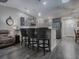 Modern kitchen with gray cabinets, stainless steel appliances, and breakfast bar at 830 Cortez Ave, The Villages, FL 32159