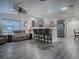 Open living space with hardwood floors and kitchen island seating at 830 Cortez Ave, The Villages, FL 32159