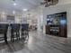 Open living area with hardwood floors, large TV, and ample natural light at 830 Cortez Ave, The Villages, FL 32159
