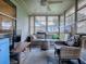 Relaxing screened porch with wicker furniture and ceiling fan at 830 Cortez Ave, The Villages, FL 32159
