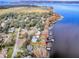 Aerial view showing home's location on lakefront property with surrounding houses at 908 N Lakeshore Blvd, Howey In The Hills, FL 34737