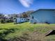 House exterior view with grassy backyard at 908 N Lakeshore Blvd, Howey In The Hills, FL 34737