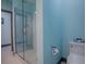 Clean bathroom with glass shower and blue mosaic tile at 908 N Lakeshore Blvd, Howey In The Hills, FL 34737